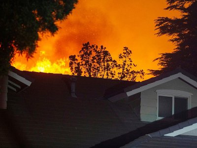 L'incendie Saddleridge Fire menace une habitation au nord de Los Angeles le 11 octobre 2019 - DAVID MCNEW [AFP]