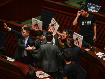 Des parlementaires pro-démocratie empêchent la cheffe de l'exécutif hongkongais Carrie Lam de prononcer son discours de politique générale dans l'hémicycle du parlement local, le 16 octobre 2019 - Ed JONES [AFP]