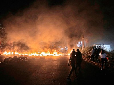 Des pneus brûlent lors de manifestations contre le pouvoir à Beyrouth, le 18 octobre 2019 - JOSEPH EID [AFP]