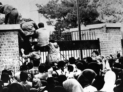 Des étudiants iraniens escaladent la grille d'entrée de l'ambassade des Etats-Unis à Téhéran, le 4 novembre 1979 - - [IRNA/AFP/Archives]