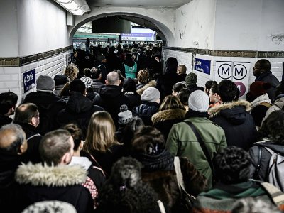 Des personnes font la queue pour accéder au quai de la ligne 1 du métro à Paris, au 8ème de grève dans les transports contre la réforme des retraites, le 12 décembre 2019 - Philippe LOPEZ [AFP]
