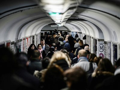Des personnes font la queue dans un couloir du métro à la station Châtelet à Paris, au 8ème de grève dans les transports contre la réforme des retraites, le 12 décembre 2019 - Philippe LOPEZ [AFP]