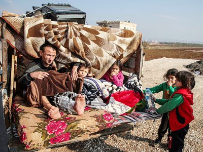 Un homme blessé est assis avec des enfants dans un camion fuyant les bombardements du régime syrien sur le sud de la province d'Idleb dans le nord-ouest de la Syrie, le 22 décembre 2019 - Aaref WATAD [AFP]