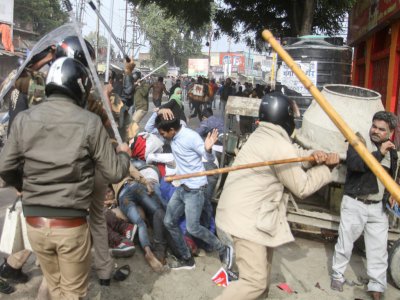 Des policiers battent des manifestants avec des "lathis", matraques en bambou, lors d'un rassemblement à Lucknow, le 19 décembre 2019 - STR [AFP]
