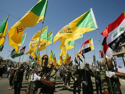 Sur cette photo d'archive, des combattants chiites irakiens des brigades du Hezbollah, groupe armé soutenu par l'Iran, défilent dans les rues de Bagdad, le 31 mai 2019 - AHMAD AL-RUBAYE [AFP/Archives]