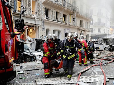 Des pompiers évacuent des blessés après une explosion rue de Trévise à Paris le 12 janvier 2018 - Thomas SAMSON [AFP/Archives]