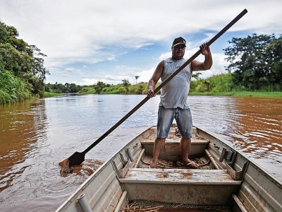 Le pêcheur Wenis Alves Rodrigues sur sa barque sur le fleuve Paraopeba, désormais pollué, dans l'Etat brésilien du Minas Gerais, le 8 janvier 2020 - DOUGLAS MAGNO [AFP]