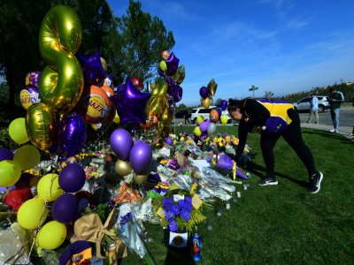 Des fans en deuil sont venus déposer fleurs et ballons à la mémoire de Kobe Bryant devant le lotissement privé où la légende du basket habitait à Newport Beach, au sud de Los Angeles - Frederic J. BROWN [AFP]