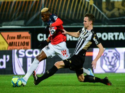 L'attaquant de Lille Victor Osimhen (g) taclé par le défenseur d'Angers Romain Thomas, le 7 février 2020 à Angers - JEAN-FRANCOIS MONIER [AFP]