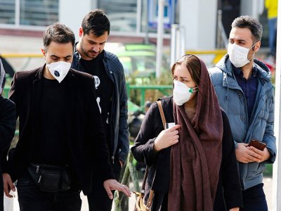 Des Iraniens portant des masques pour se protéger du nouveau coronavirus, à Téhéran, le 22 février 2020 - ATTA KENARE [AFP]