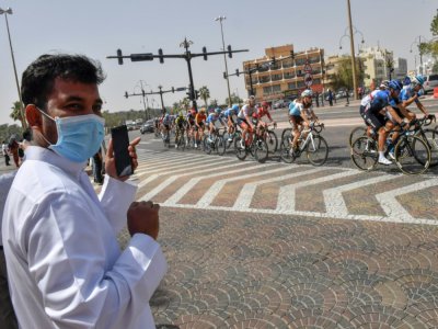 Un homme portant un masque chirurgical pendant la 5e étape du Tour des Emirats, le 27 février 2020 - Giuseppe CACACE [AFP]