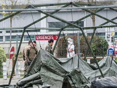 Des soldats préparent le matériel pour installer un hôpital militaire sur le parking de l'établissement Emile Muller  à Mulhouse, le 21 mars 2020 - SEBASTIEN BOZON [AFP]