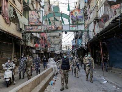 Des soldats libanais portant des masques patrouillent dans le quartier de Sabra près de Beyrouth, où vivent de nombreux réfugiés palestiniens, pour s'assurer du respect des restrictions imposées face au nouveau coronavirus, le 22 mars 2020 - ANWAR AMRO [AFP]