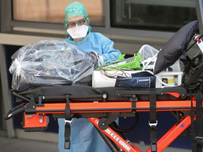 Une infirmière desinfecte une ambulance ayant transporté six malades du Covid-19, le 24 mars 2020 - JEAN-FRANCOIS MONIER [AFP/Archives]