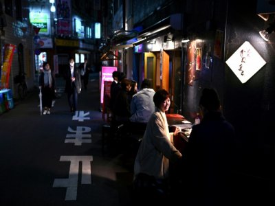 Des gens mangent dans un restaurant dans le quartier de Shinbashi à Tokyo, le 17 avril 2020 - CHARLY TRIBALLEAU [AFP]