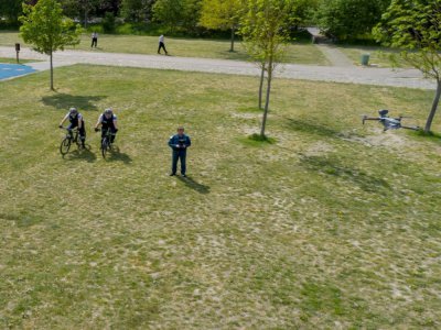 Des policiers actionnent un drone de surveillance dans un espace vert à Metz, le 24 avril 2020 pour traquer les contrevenants au confinement - JEAN-CHRISTOPHE VERHAEGEN [AFP]
