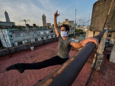 Le danseur Adrián Sánchez, premier soliste du Ballet national cubain, s'exerce sur le toit de sa maison, le 21 avril 2020 à La Havane - YAMIL LAGE [AFP]