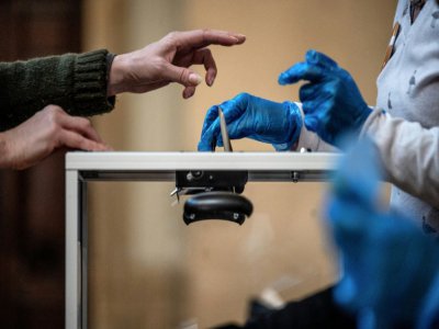 Premier tour des élections municipales, le 15 mars 2020, dans un bureau de vote à Lyon, deux jours avant le confinement - JEFF PACHOUD [AFP/Archives]