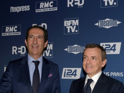 Patrick Drahi (g) et Alain Weill en octobre 2018 à Paris - ERIC PIERMONT [AFP/Archives]