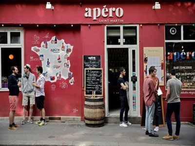 Des Parisiens prennent un verre devant un bar près du Canal Saint-Martin à Paris le 24 mai 2020 - THOMAS COEX [AFP]