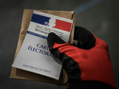 Une personne vote, gantée, le 15 mars 2020 à Paris - Philippe LOPEZ [AFP/Archives]