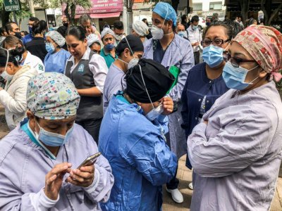 Des patients d'une clinique de Mexico sortent dans la rue après un violent séisme, le 23 juin 2020 - Pedro PARDO [AFP]