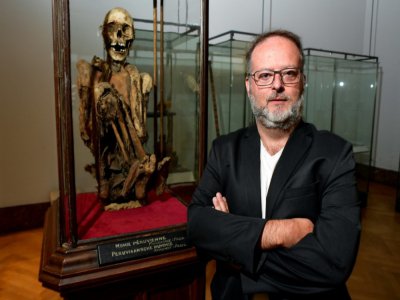 Serge Lemaitre, conservateur des collections Amériques Musée Art et Histoire (MAH) de Bruxelles, à côté d'une momie péruvienne au squelette recroquevillé, le 13 juillet 2020 à Bruxelles - JOHN THYS [AFP/Archives]