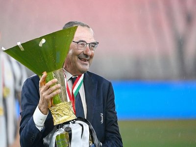 L'entraîneur de la Juventus Maurizio Sarri pose avec le trophée de Champion d'Italie, le 1er août 2020 à Turin - Isabella BONOTTO [AFP/Archives]