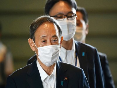 Yoshihide Suga (à gauche) arrive au bureau du Premier ministre à Tokyo, le 16 septembre 2020 - Kazuhiro NOGI [AFP]