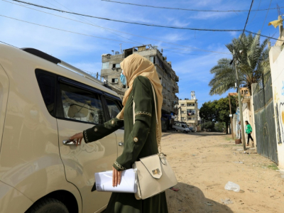 Une cliente monte dans le taxi de Nayla Abou Jubbah, le 17 novembre 2020 à Gaza - MAHMUD HAMS [AFP]