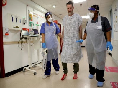 Des infirmières aident le patient Justin Fleming à remarcher après avoir été malade du Covid-19, à l'hôpital King's College de Londres (Royaume-Uni) le 27 janvier 2021. - Kirsty Wigglesworth [POOL/AFP]