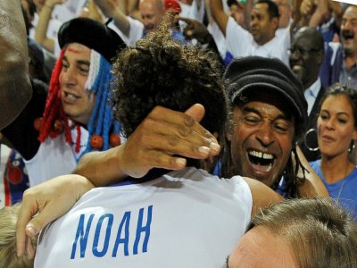 Joakim Noah embrasse son père Yannick Noah après la victoire de l'équipe de France en demi-finale de l'Euro-2011 contre la Russie le 16 septembre 2011 à Kaunas - JANEK SKARZYNSKI [AFP/Archives]