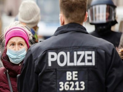 Une femme proteste contre les restrictions sanitaires à Berlin le 28 mars 2021 - John MACDOUGALL [AFP]