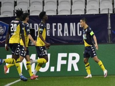 L'attaquant de Monaco, Wissam Ben Yedder, exulte après avoir ouvert le score sur pénalty contre Lyon, lors de leur quart de finale de la Coupe de France, le 21 avril 2021 au Groupama Stadium à Décines-Charpieu, près de Lyon - PHILIPPE DESMAZES [AFP]