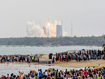 Des passionnés se sont rassemblés sur les plages aux alentours du centre de lancement de Wenchang, dans le Hainan (sud de la Chine) pour voir le lancement du premier des trois éléments de la station spatiale chinoise, le 29 avril 2021 - STR, STR [AFP]