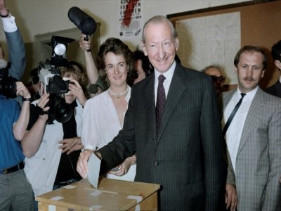 Le politicien autrichien Kurt Waldheim (c) vote pour le premier tour de la présidentielle à laquelle il se présente, le 4 mai 1986 à Vienne - Daniel JANIN [AFP/Archives]