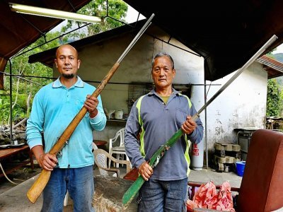 Le chasseur aborigène Bunun Tama Talum (d) et l'un de ses voisins, le 30 avril 2021 dans le village de Chishang, à Taïwan - Sam Yeh [AFP]