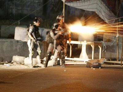 De soldats israéliens lancent du gaz lacrymogène vers des manifestants palestiniens au point de passage de Qalandiya, entre les villes de Ramallah et Jérusalem, en Cisjordanie, le 11 mai 2021 - ABBAS MOMANI [AFP]