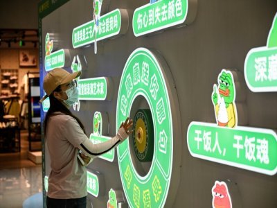 Une femme visite une exposition consacrée à Pepe The Frog, symbole de la désillusion de la jeunesse chinoise, dans un centre commercial de Pékin, le 29 mai 2021 - Jade GAO [AFP]