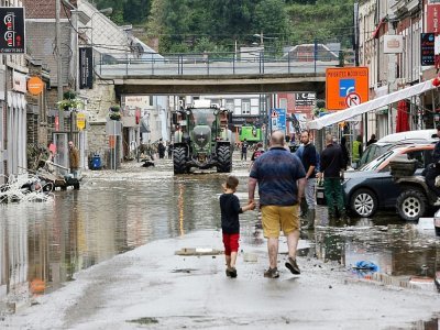 Des habitants dans une rue inondée, le 16 jullet 2021 à Pepinster, en Belgique - François WALSCHAERTS [AFP]