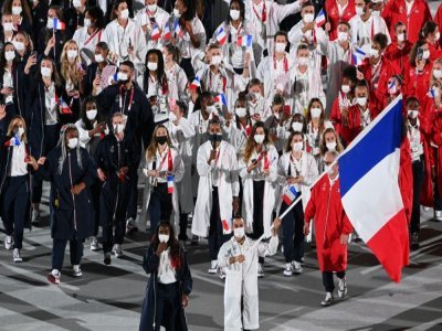 Les porte-drapeaux français Clarisse Agbegnenou et Samir Ait Said, mènent la délégation française, lors de la cérémonie d'ouverture des Jeux Olympiques, le 23 juillet 2021 au Stade Olympique à Tokyo - Martin BUREAU [AFP]