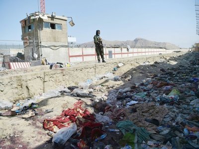 Un combattant taliban se tient face au site d'un attentat à la bombe à l'aéroport de Kaboul le 27 août 2021 - WAKIL KOHSAR [AFP]