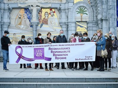 Des membres du collectif Les 4 R réclament justice devant la basilique Notre-Dame-du-Rosaire à Lourdes, le 6 novembre 2021 - Valentine CHAPUIS [AFP]