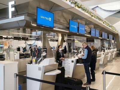 Des voyageurs à l'aéroport de LaGuardia, le 24 décembre 2021 à New York - Yuki IWAMURA [AFP]