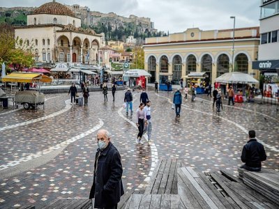 Dans les rues d'Athènes, des passants masqués le 29 décembre 2021 - Angelos Tzortzinis [AFP]
