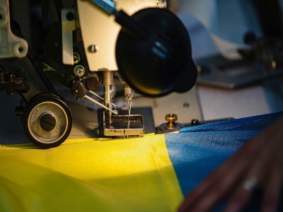 Un drapeau aux couleurs de l'Ukraine en train d'être confectionné dans l'atelier Borney d'Argentan, dans l'Orne, le 8 mars 2022 - Sameer Al-DOUMY [AFP]