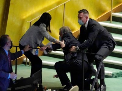Le secrétaire général de l'ONU, Antonio Guterres, aidé après être tombé en quittant l'hémicycle de l'Assemblée générale des Nations unies le 2 mars 2022 - TIMOTHY A. CLARY [AFP/Archives]