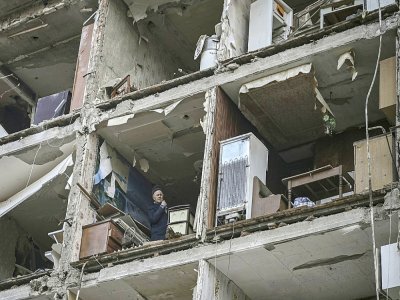 Un homme dans un appartement d'un immeuble détruit par un bombardement russe, le 25 mars 2022 à Kharkiv, en Ukraine - Aris Messinis [AFP]