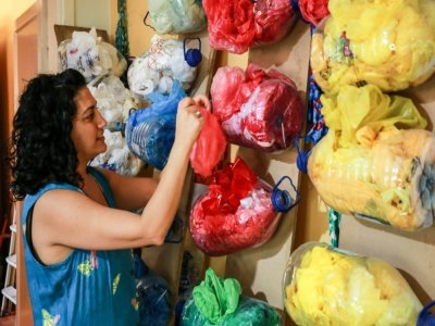 Maria Nissan, une Américaine d'origine irakienne, range des sacs en plastique le 17 mai 2022 à Amman pour s'en servir pour faire des oeuvres artistiques - Khalil MAZRAAWI [AFP]