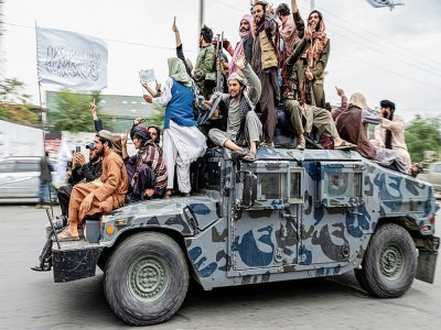 Des combattants talibans défilent sur un véhicule blindé dans les rues de Kaboul (Afghanistan) pour célébrer l'anniversaire de leur victoire, le 15 août 2022 - Wakil KOHSAR [AFP]